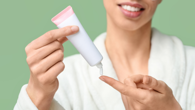 a woman in her thirties applying sunscreen